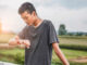 male teenager looking at watch checking running distance and heart rate