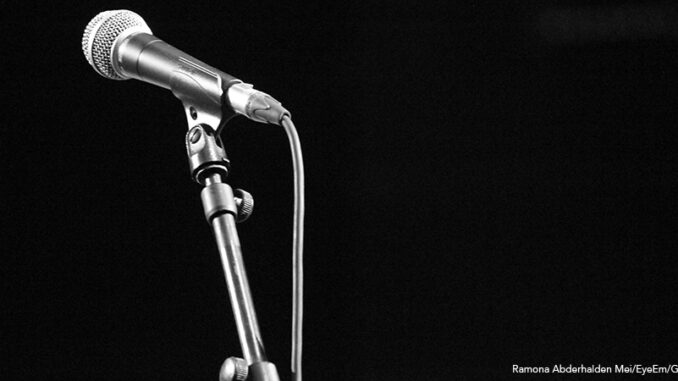 Close-Up Of Microphone In Darkroom Close-Up Of Microphone on stand with a black background