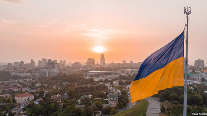 040422_03P_FS Aerial view of the Ukrainian flag waving in the wind against the city of Kyiv