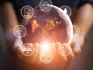 Earth Day concept graphic. The globe of the Earth at night, surrounded by holding hands. There are energy resources icons surrounding the globe image..