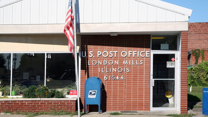 LONDON MILLS, IL-MAY, 2015: Local small town post office in the midwest. Small post offices like these are increasingly in danger of being closed due to budget constraints. Exterior view of a United States Post Office building