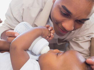 father feeding his baby from a bottle