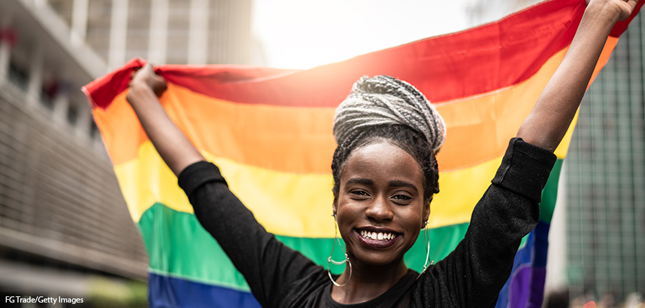 Woman Waving Rainbow Flag at Pride Parade