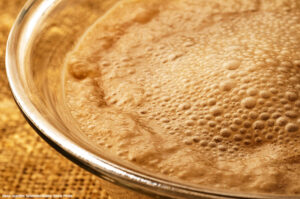 a close up of a bowl of bubbling yeast