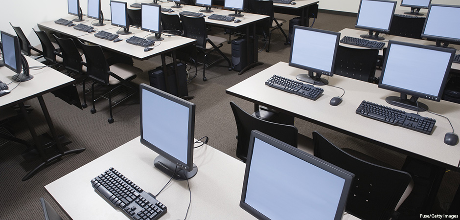 computer lab with desks showing keyboards, monitors