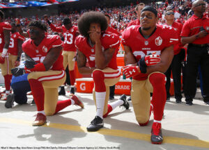 Colin Kaepernick (center), and teammates knelt during the  National Anthem in 2016.