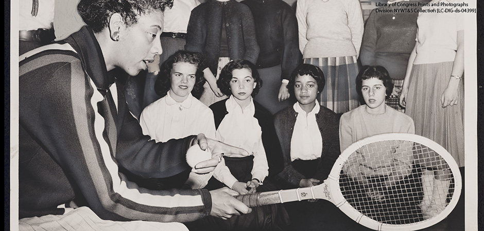 In this 1957 black and white photograph, Althea Gibson, U.S. and Wimbledon tennis champion, gives some pointers on the game which has brought her international fame.