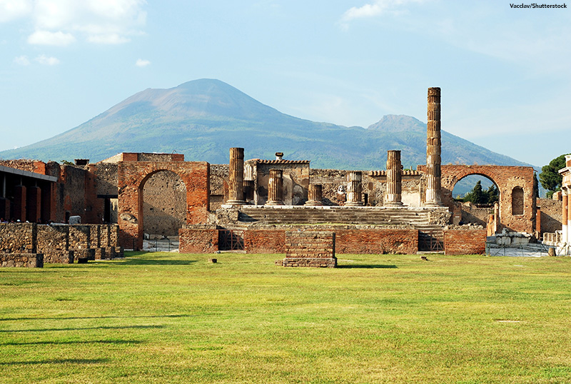 View of the Pompeii ruins in italy with Mount Vesuvius in background.