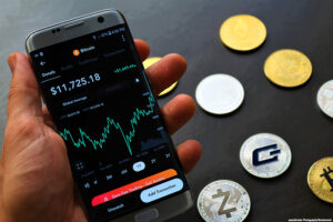 Closeup of a Cryptocurrency app with coins on a dark background.