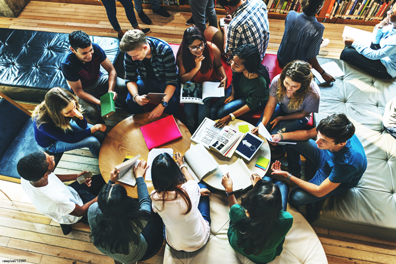 students sitting in a circle on the floor discussing subject matters