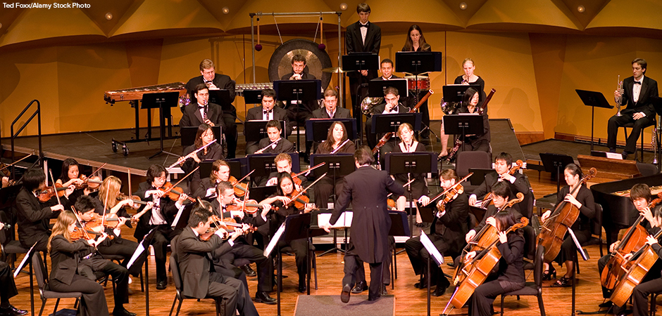 Music Director Kimo Furumoto directs student musicians or the California State University Fullerton Orchestra in a concert.