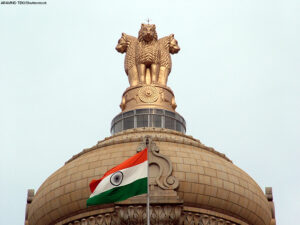 India's flag flying in front of building dome