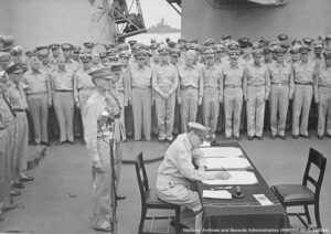 photo of Gen. Douglas MacArthur signing the surrender documents that ended U.S. fighting with Japan during World War II on September 2, 1945.