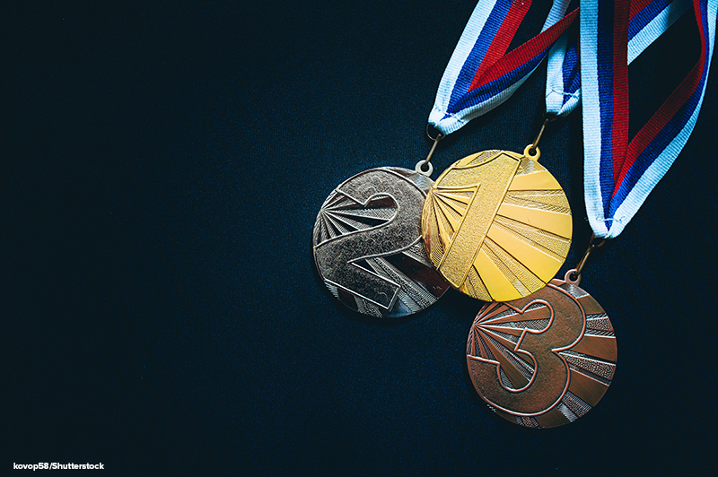 Gold, silver and bronze medals shown on a black background.