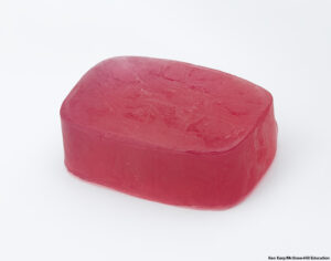 Cut-out of a colorful bar of soap against a white background