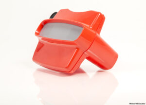 Red plastic View-Master toy against a white background