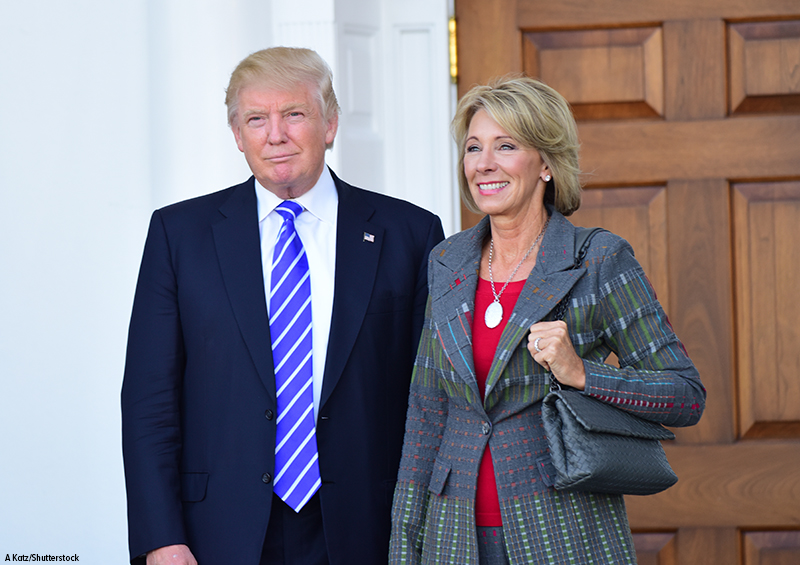 Photograph of Donald  Trump and Betsy DeVos.