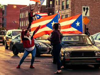 Hundreds of cars form a caravan in the Humboldt Park neighborhood to express Puerto Rican pride