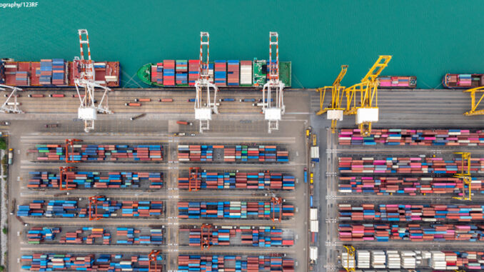 commercial port loading and unloading cargo from container ship