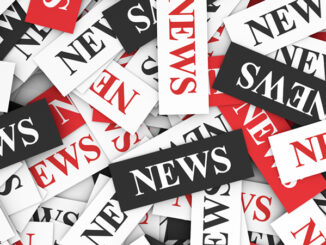 News concept background with a multitude of sign and text on scattered paper.