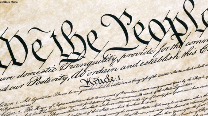 photo of the first page of a reproduction of the United States Constitution