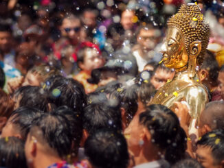 Buddha statue being carried in the water ceremony at a Songkran festival.