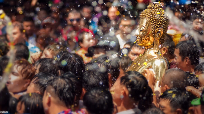 Buddha statue being carried in the water ceremony at a Songkran festival.