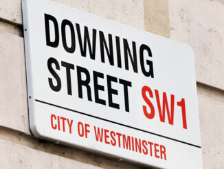 Oblique view of the Downing Street street sign on a building in the City of Westminster, London, England.