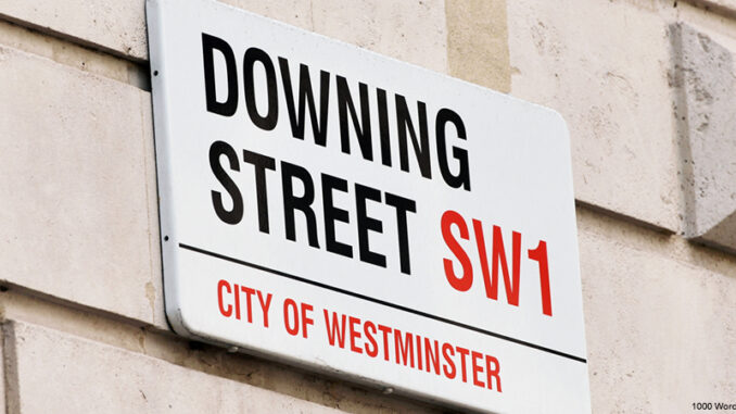Oblique view of the Downing Street street sign on a building in the City of Westminster, London, England.