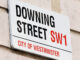 Oblique view of the Downing Street street sign on a building in the City of Westminster, London, England.
