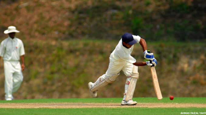 A cricket batsman getting ready to hit